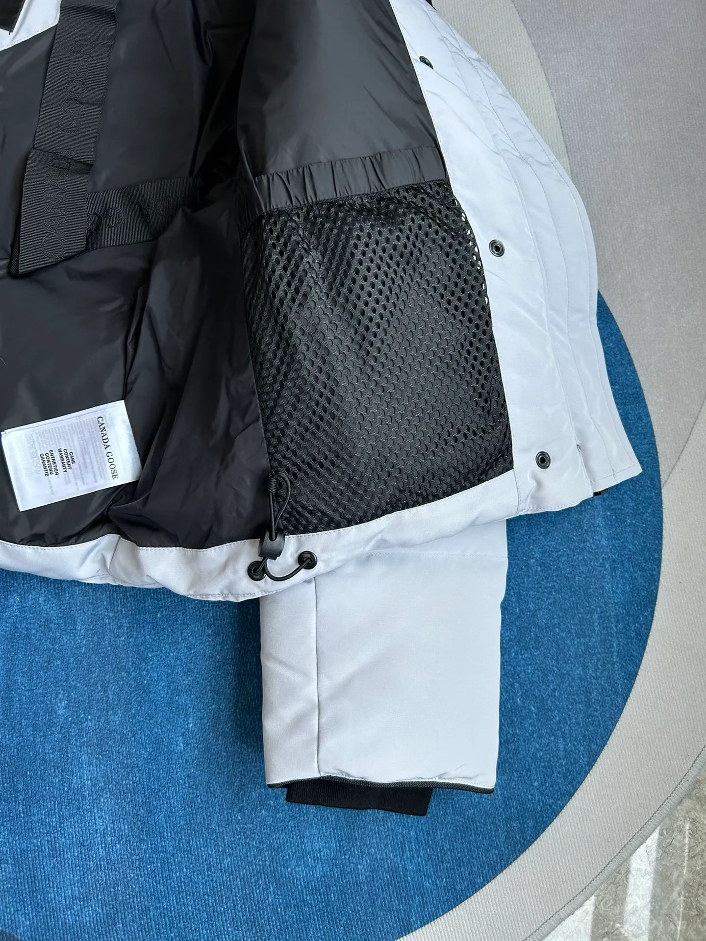 P880 E2266WB Grandview black label short jacket down jacket. Constructed from Arctic Tech recycled fabric®, it features a cinchable hem for sleek styling and storage. Color: White Star White. Size: XS S M L XL.
